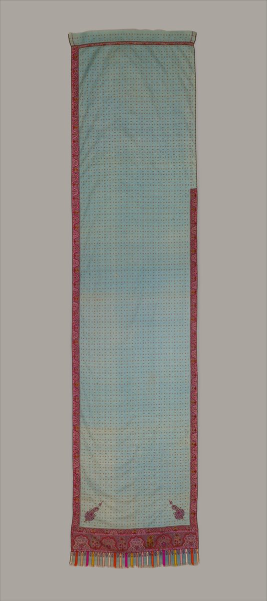 Long pale blue Kashmir wool sari with a small repeating pattern, deep pink paisley borders, and multicolored tassels