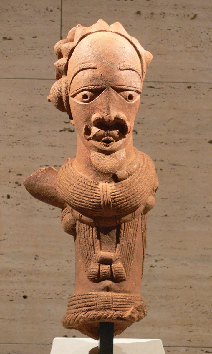 Nok terracotta male figure wearing a heavy beaded collar, strands of beads, and a belt