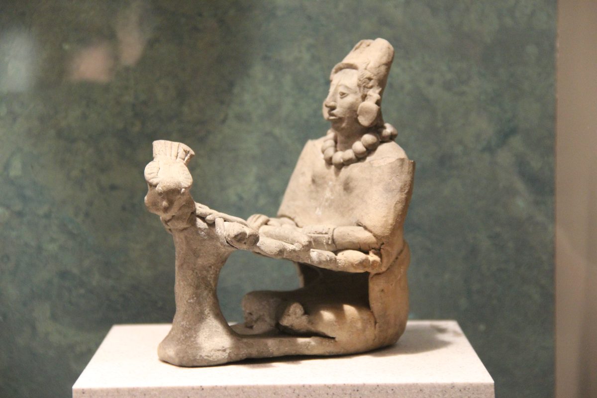 Maya clay figurine of a woman weaving on a backstrap loom