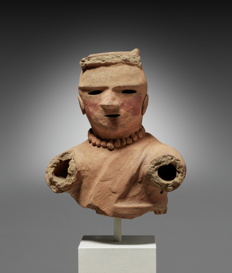 Clay haniwa figure of a woman with red facial markings and a bead necklace, wearing a wrapped jacket