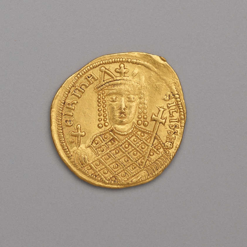 Gold coin showing the bust of Empress Irene facing forward in a tall crown with hanging strings of pearls, her chest covered by a jeweled loros in a lattice pattern, holding an orb with a cross and a cross-topped scepter