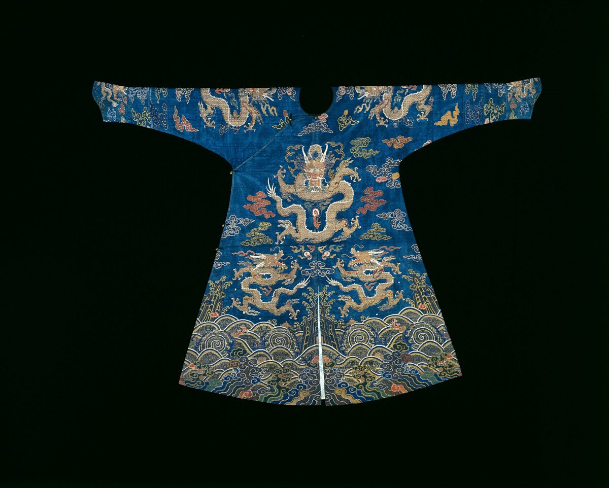 Blue silk Qing dragon robe with gold dragons among clouds above a band of stylized waves and mountains at the hem
