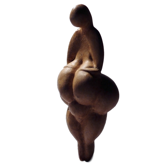 Replica of a figurine of a woman with exaggerated breasts and hips and a small, featureless head