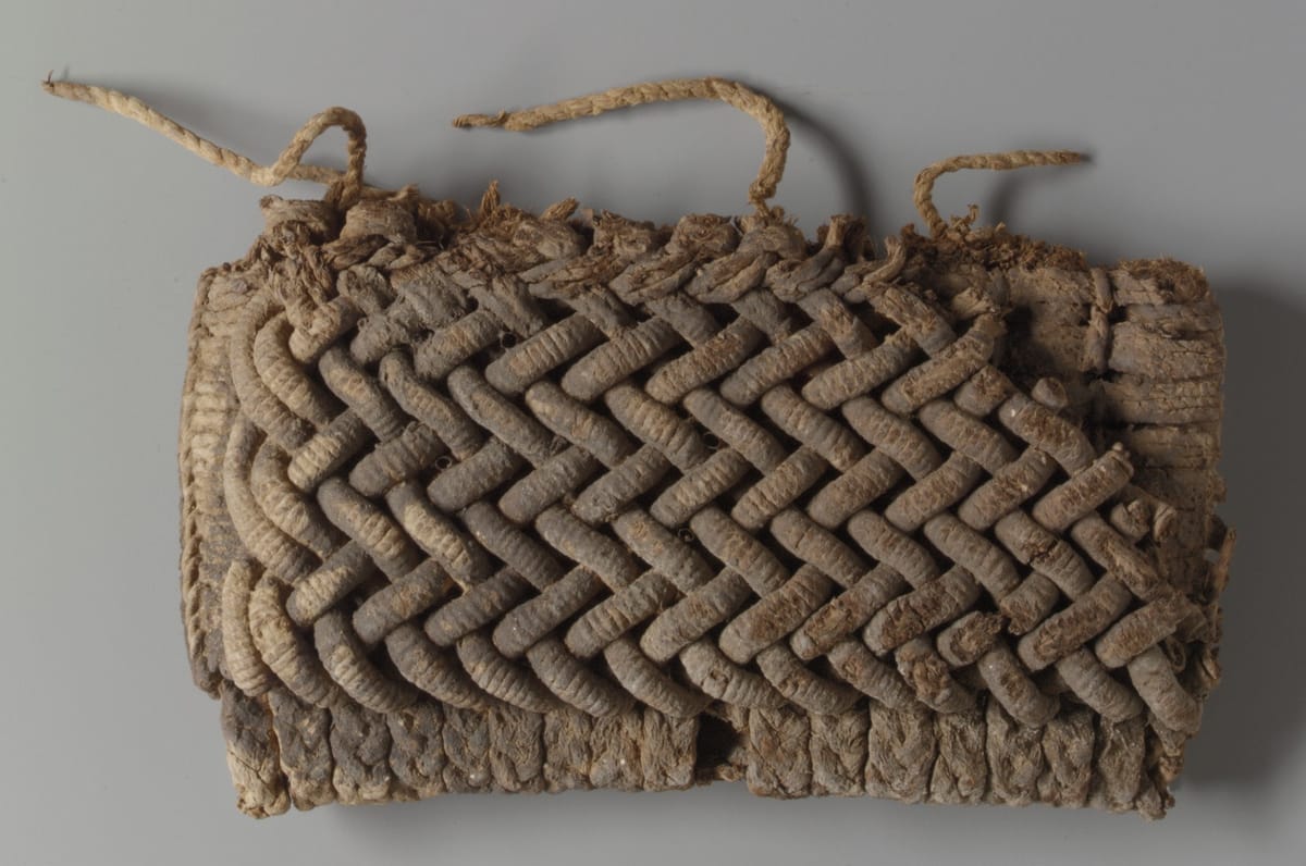 Tellem fiber cache-sexe, a skirt of plaited and twined cord built up in layers