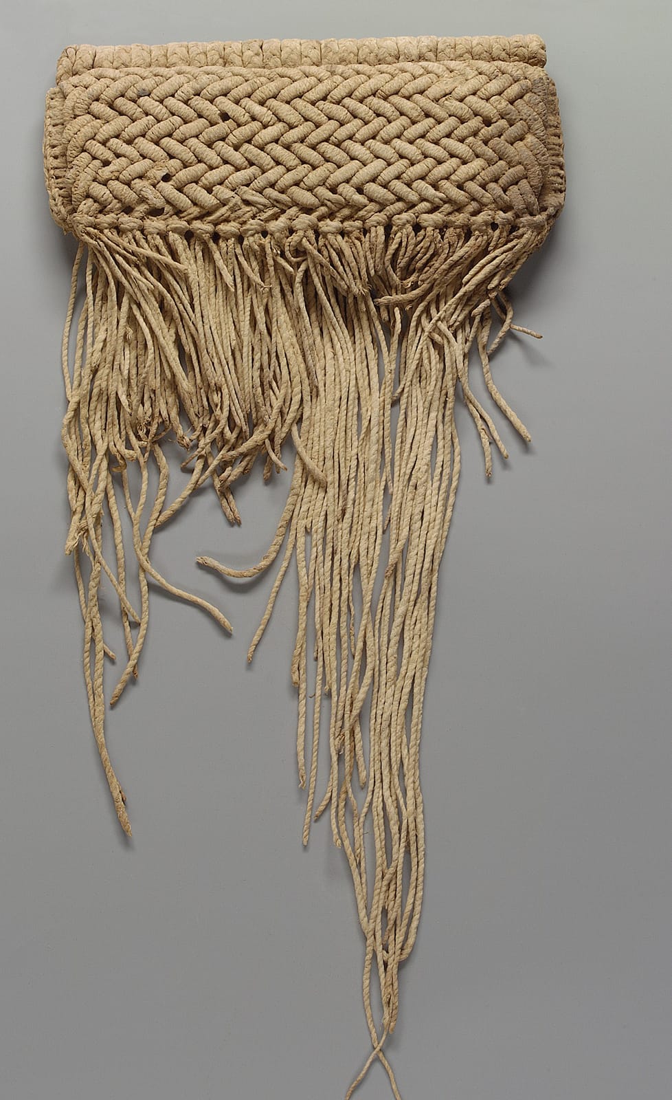 Tellem fiber frontal garment, a thick plaited waistband from which long twisted cords hang down as a fringe