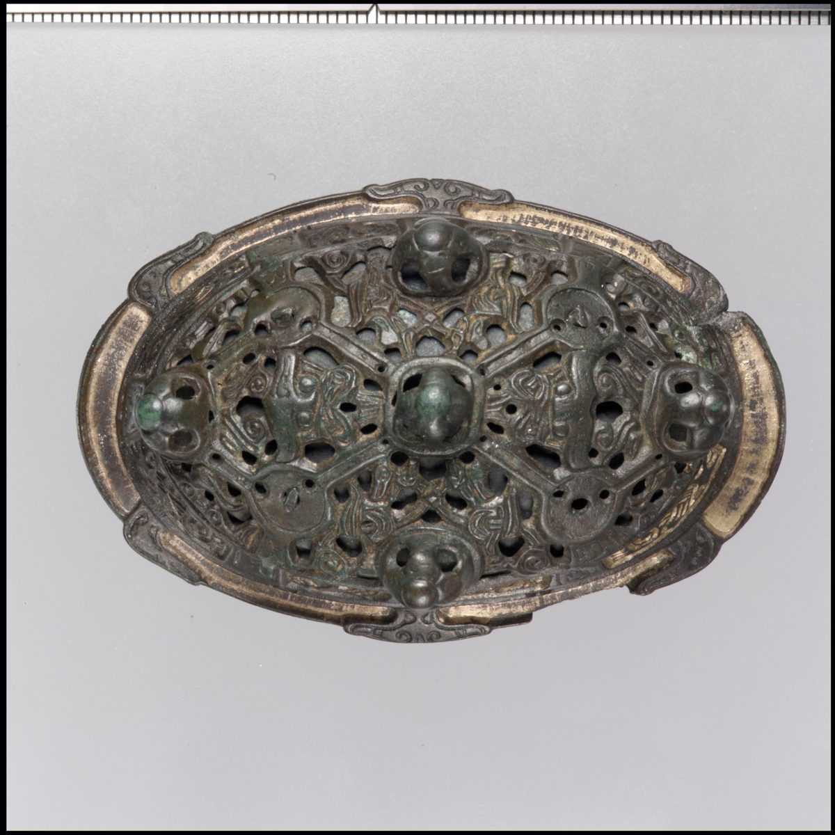 A Viking oval brooch of copper alloy with openwork animal decoration