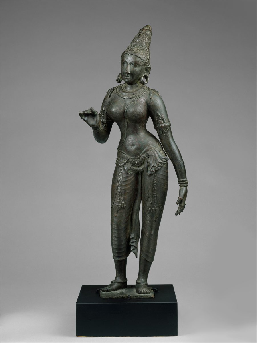 Chola bronze of a standing Parvati in a pleated lower garment with a jewelled girdle, armlets, and a tall crown