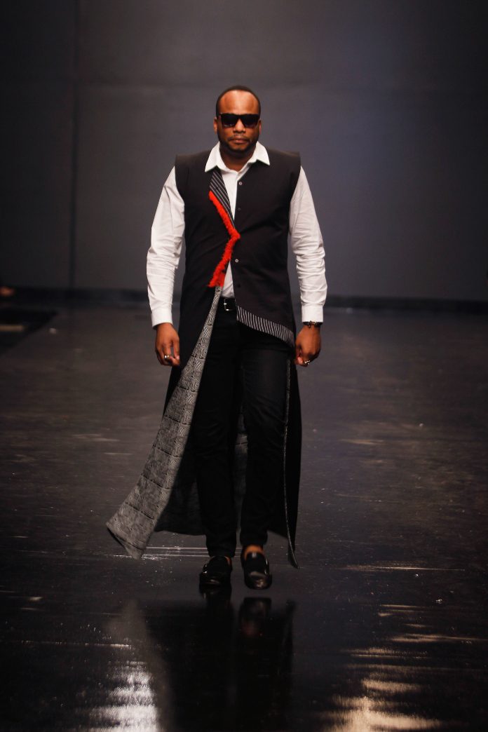 Model Olufeko on the runway at Lagos Fashion Week 2018 in a design by Kiki Kamanu