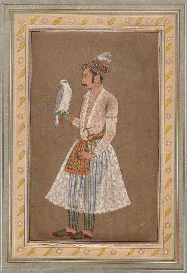 Mughal portrait of Raja Jagat Singh of Nurpur holding a falcon on his gloved hand, wearing a long white jama with a sheer pink bodice and a full skirt patterned in gold, a patterned patka sash with a deep fringed end, striped trousers, and a chequered turban with a white plume