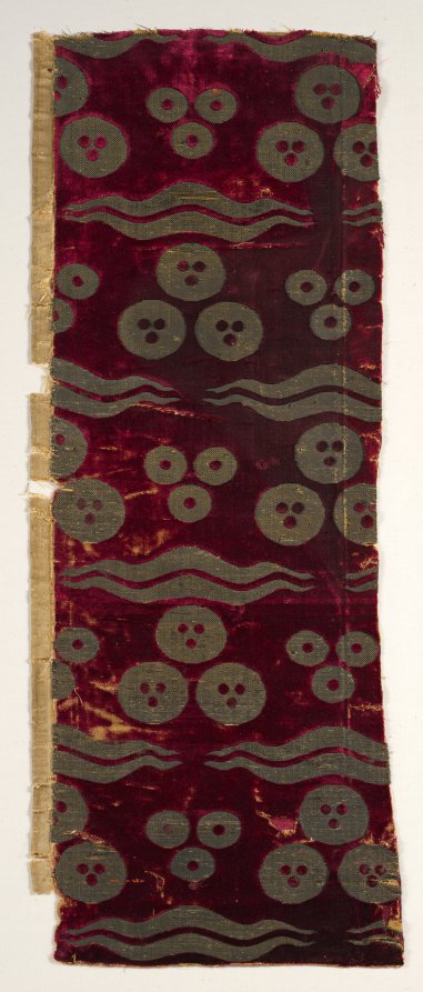 Panel of deep crimson silk velvet brocaded with three gold balls above paired wavy bands in a repeating pattern