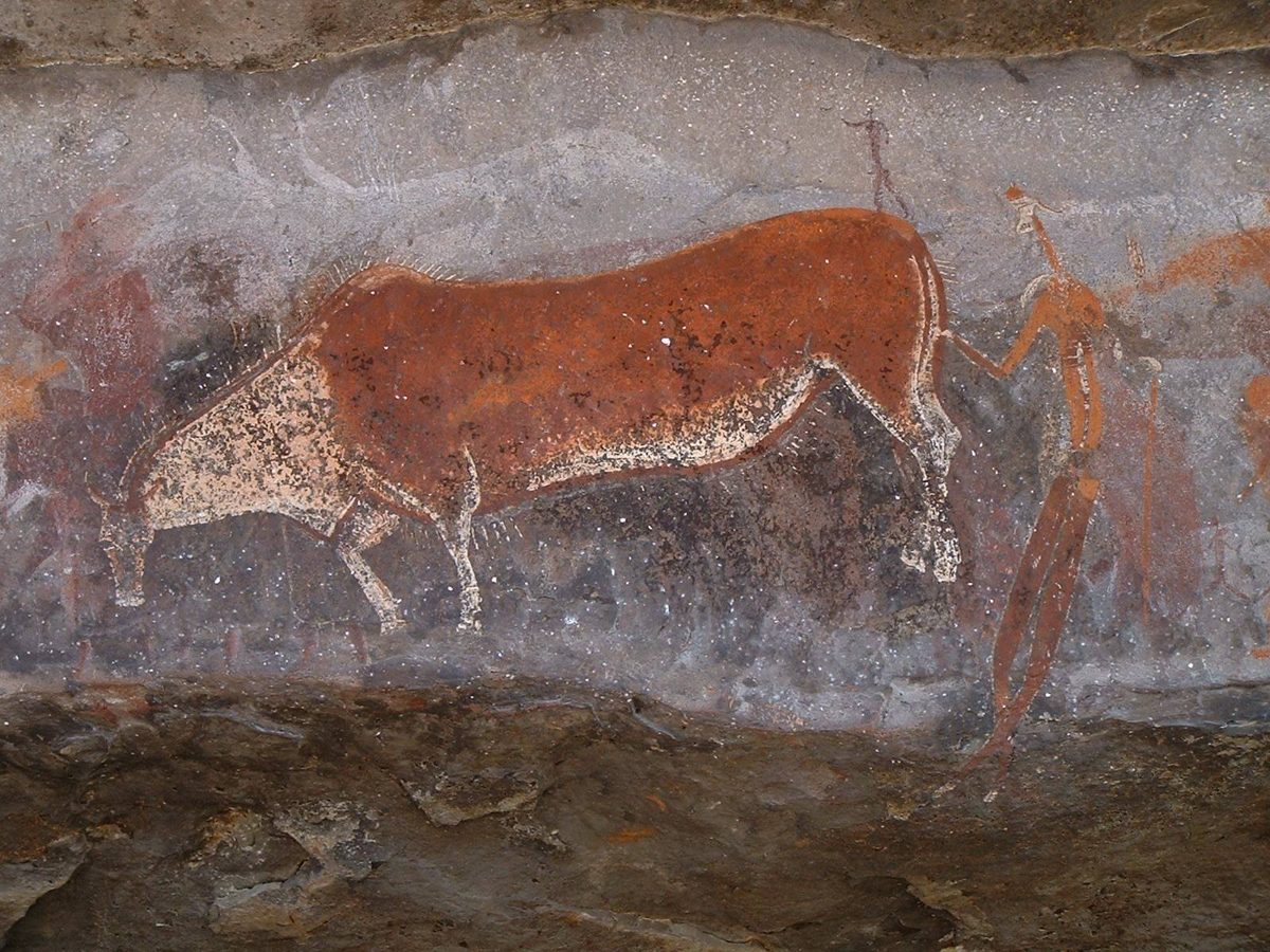 San rock painting of a human figure holding the tail of an eland, Game Pass Shelter, Kamberg, South Africa