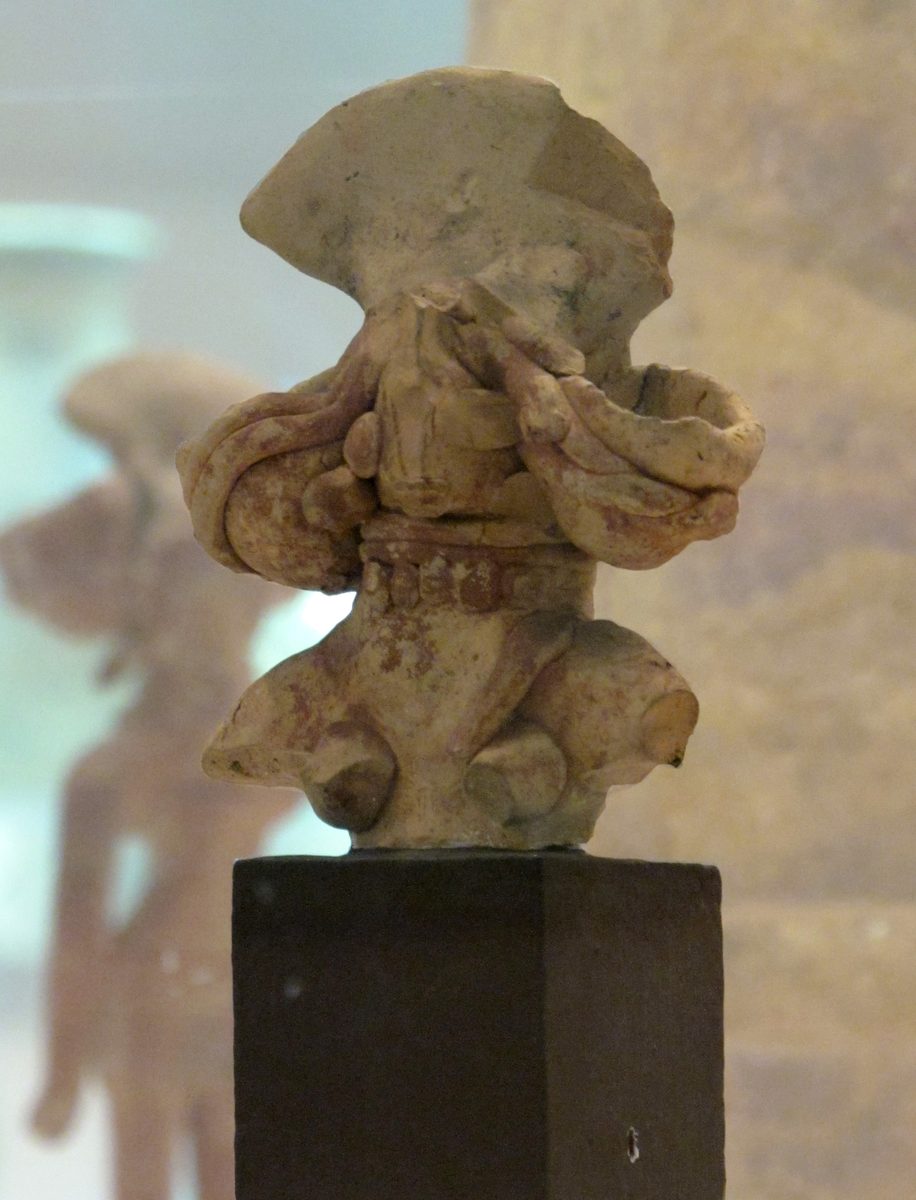 Terracotta female figurine from a Mature Harappan site, with a fan-shaped headdress, side ornaments, and layered necklaces