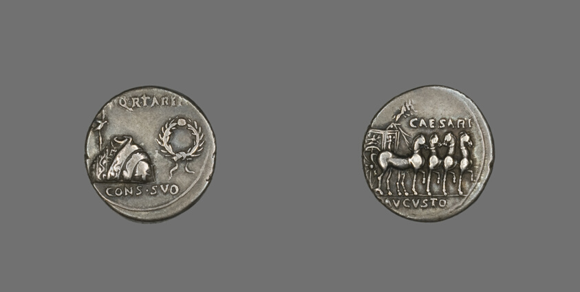 Silver coin of about 18 BCE showing a toga, a tunic and a wreath on one side and a four-horse chariot on the other